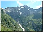 On the other side of the pass which can be seen in the top left. The way down is long, steep, knee-jarring, awful.